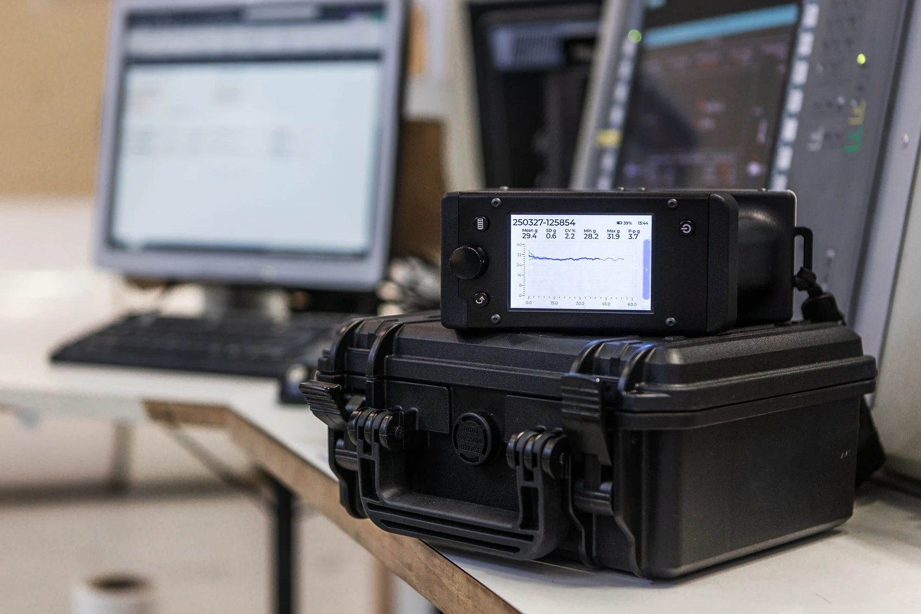 Tapio RQP Live on its carry case at a winder control desk, showing a hardness profile with mean, SD and CV.