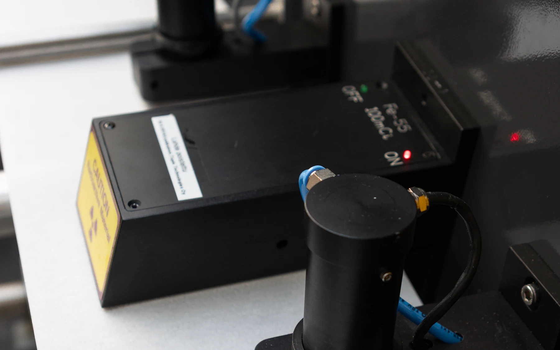 Tapio ash sensor: the Fe-55 low-energy source housing above the paper strip in the analyzer.
