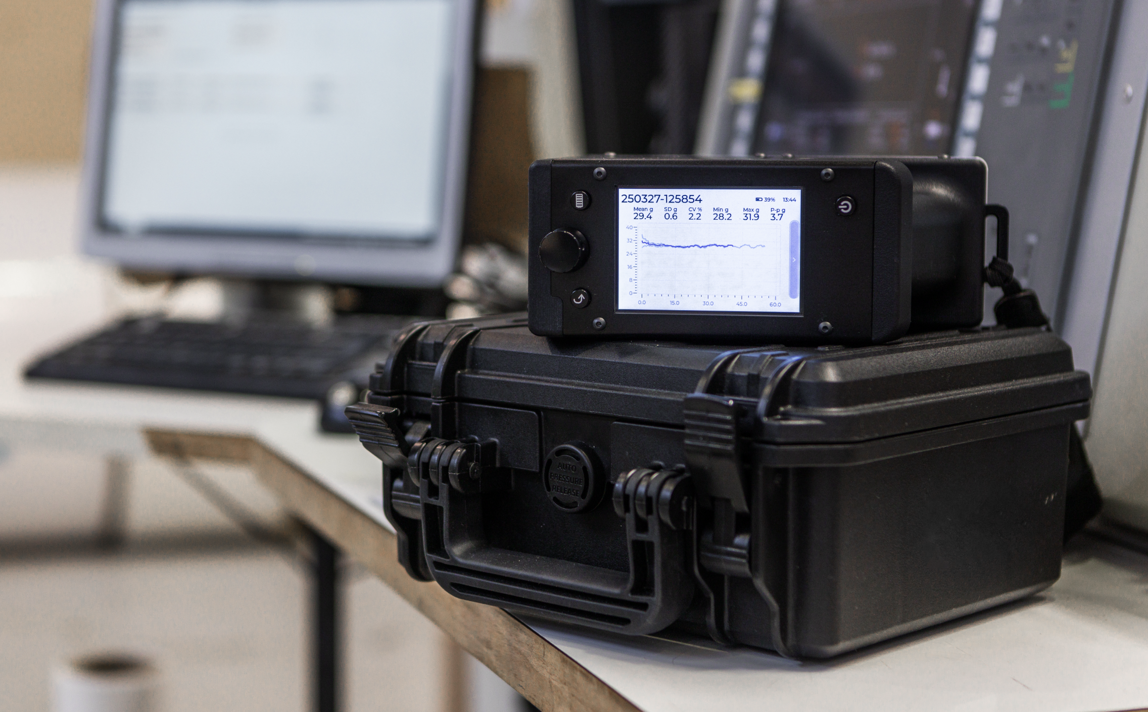 Tapio RQP Live device with a graphical display showing a roll hardness profile, placed on a black protective case in an industrial environment.