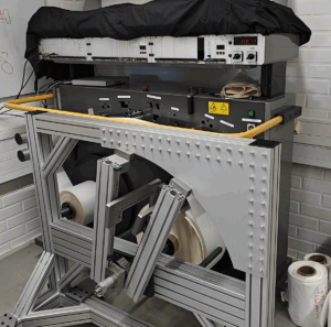 Laboratory setup of a Tapio Analyzer at Aalto University, showing the winding frame, caliper measurement system and multi-probe roundness measurement equipment.
