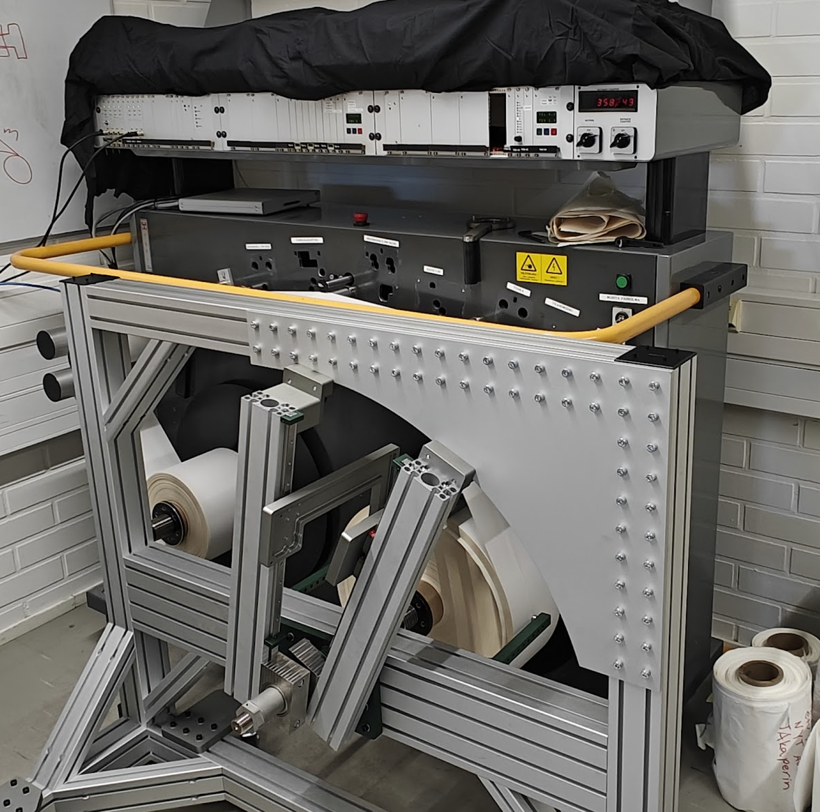 Laboratory setup of a Tapio Analyzer at Aalto University, showing the winding frame, caliper measurement system and multi-probe roundness measurement equipment.
