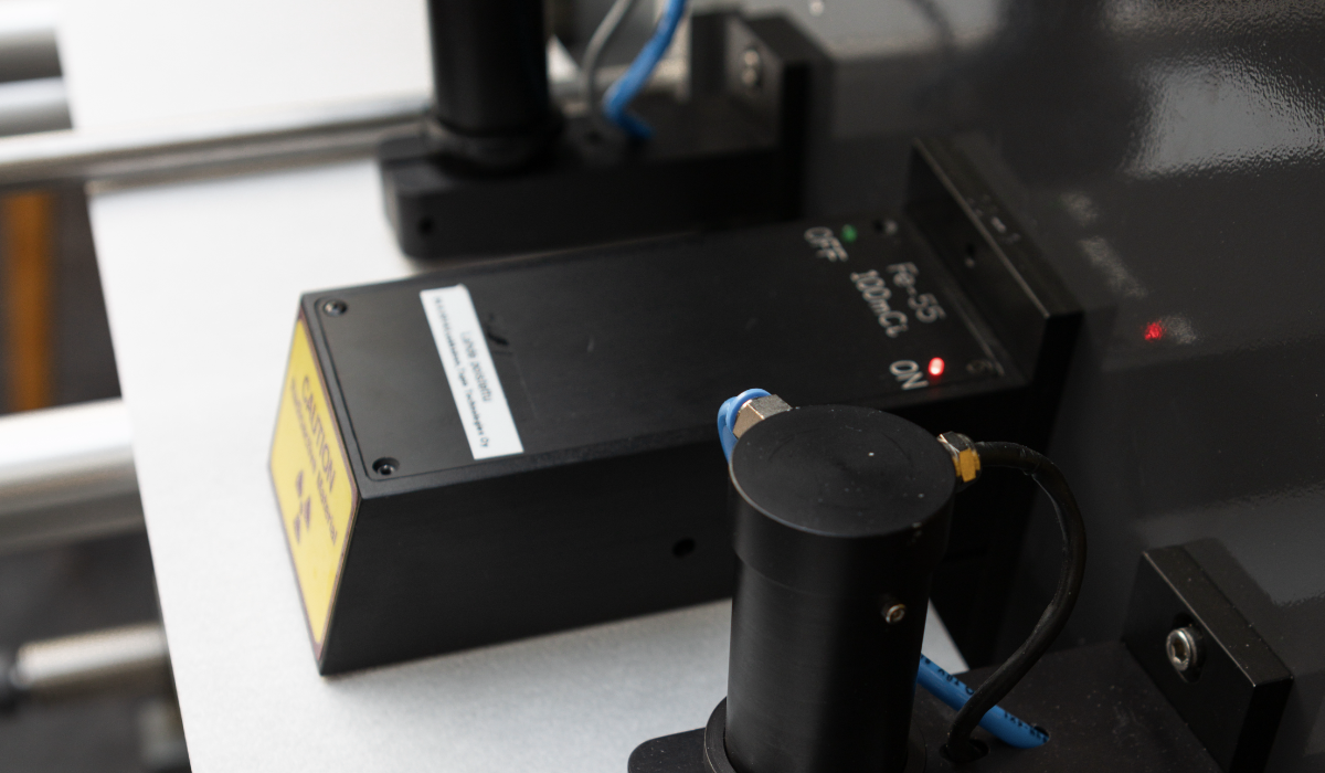 Tapio Ash Sensor measuring filler content in coated paper using low-energy gamma radiation.