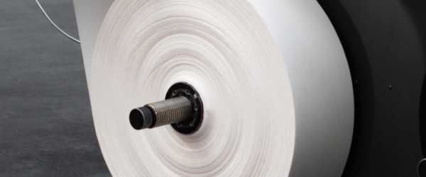 Large white paper sample roll mounted on a Tapio Analyzer, prepared for machine direction quality measurement.